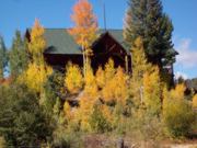 A thumb nail view of Grand Lake, Colorado during Constitution Week in September looking at a beautiful lake front home with a yard full of colorful aspen trees changing colors; click here to open a window with a larger picture.